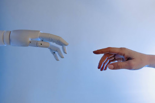 robot hand reaching out for human hand inspired by michaelangelo’s creation of adam